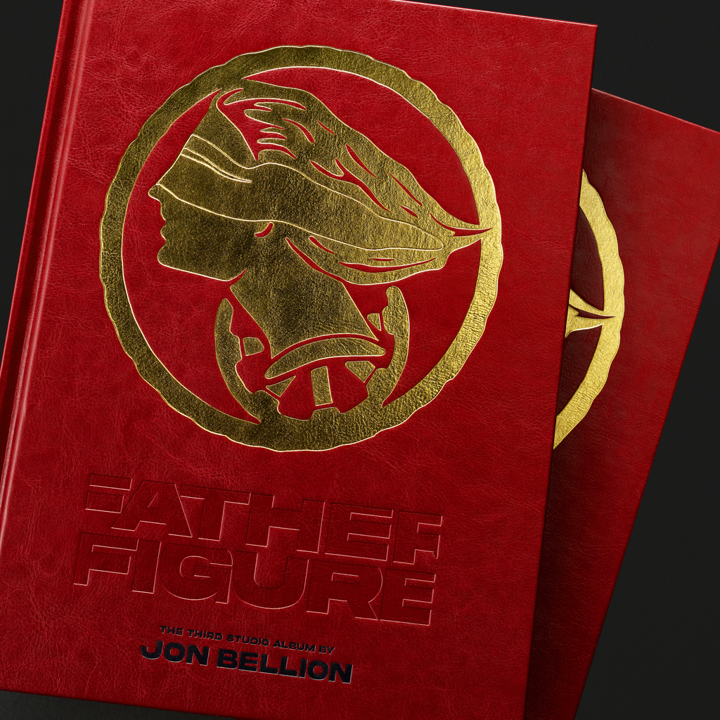 Father Figure Legacy Edition — two hardcovers stacked, close-up of gold debossed profile on red cover,  a collaboration between Mendy and Jon Bellion