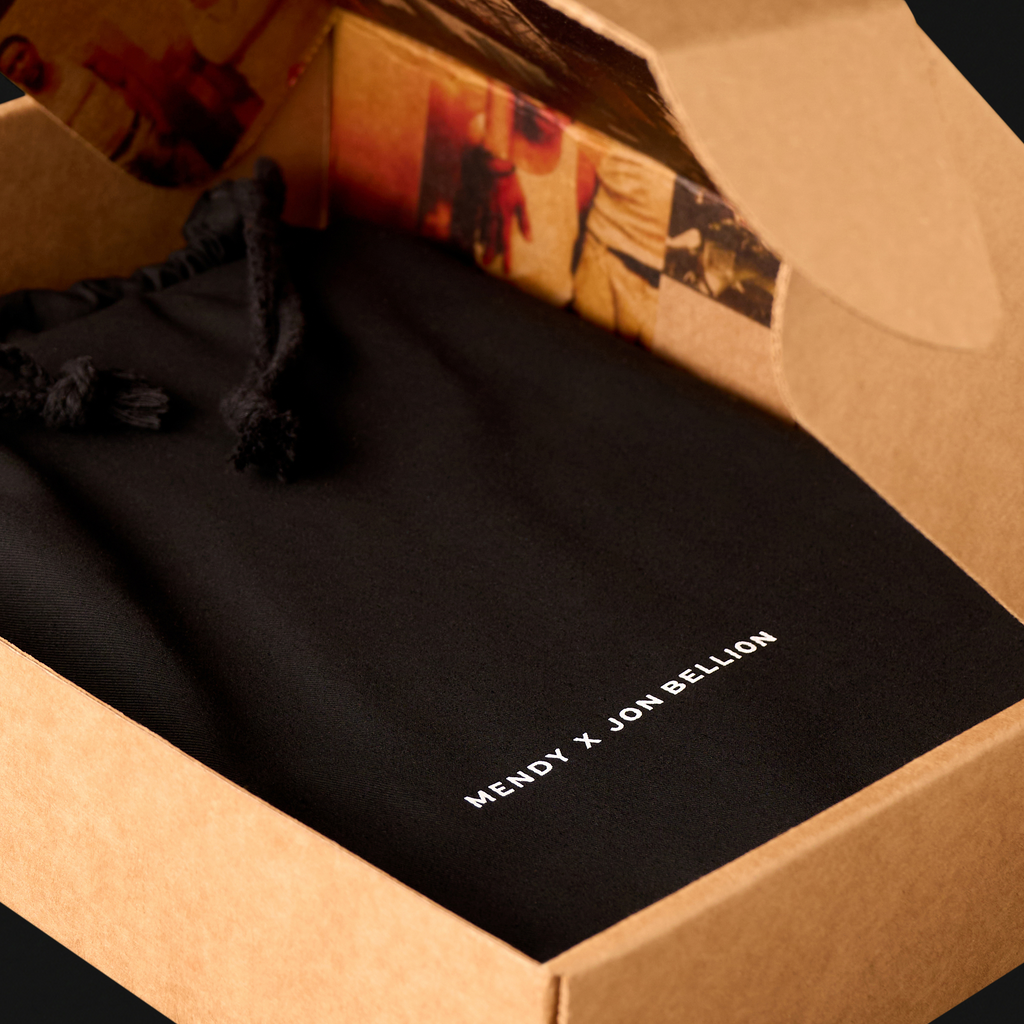 Father Figure Legacy Edition unboxing — Mendy x Jon Bellion dust bag inside kraft archival storage box, a collaboration between Mendy and Jon Bellion