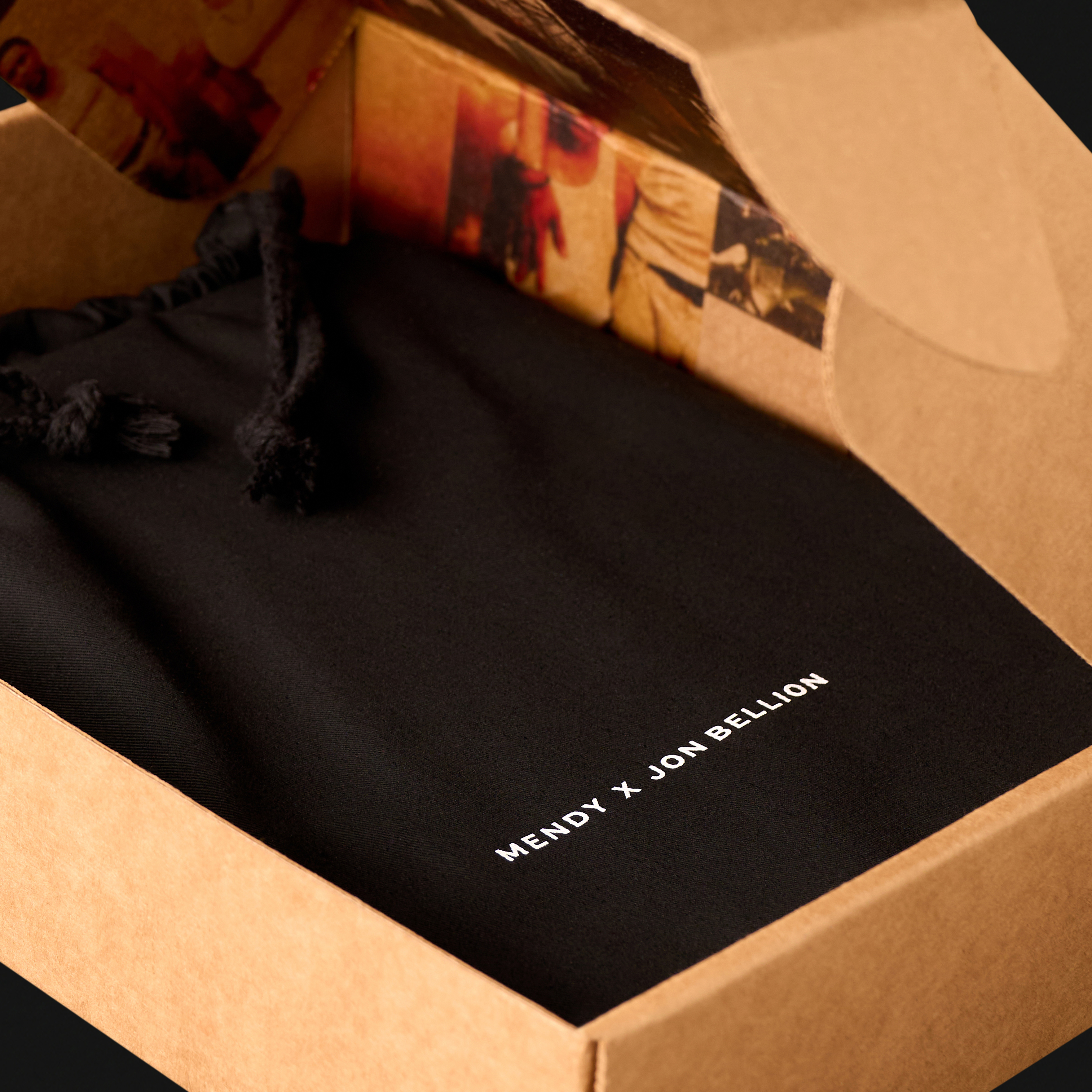 Father Figure Legacy Edition unboxing — Mendy x Jon Bellion dust bag inside kraft archival storage box, a collaboration between Mendy and Jon Bellion