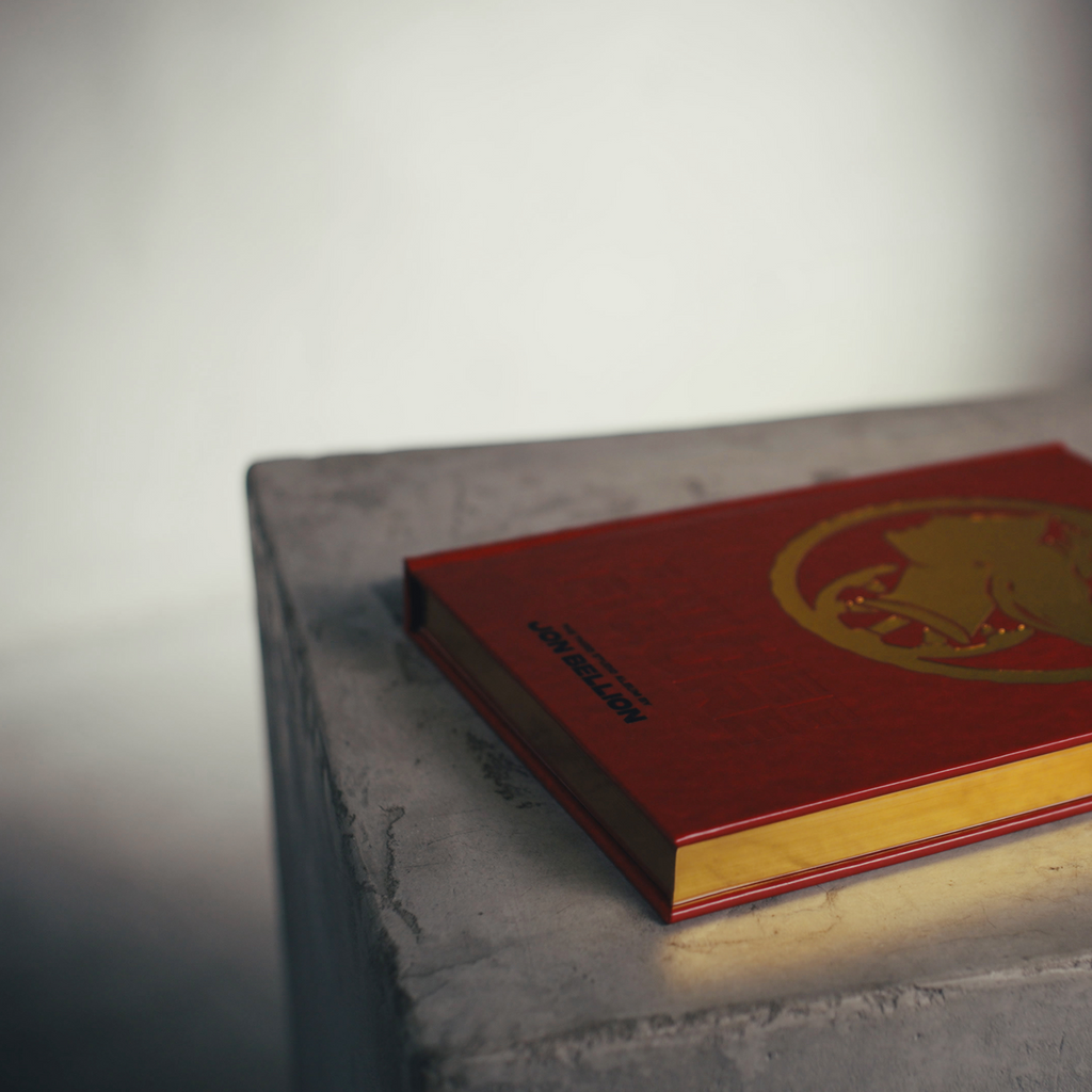 Father Figure Legacy Edition hardcover showing gilt gold page edges, red cover with gold debossed profile, a collaboration between Mendy and Jon Bellion